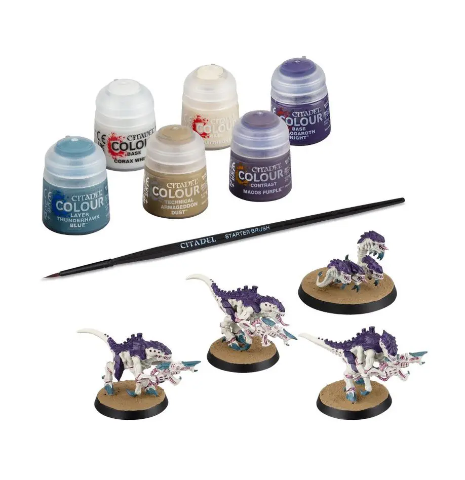 Painted miniature fantasy creatures with paint pots and brush.