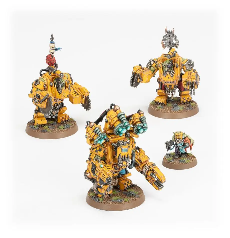 Miniature yellow-armored warriors with mechanical and weaponized features on round bases.