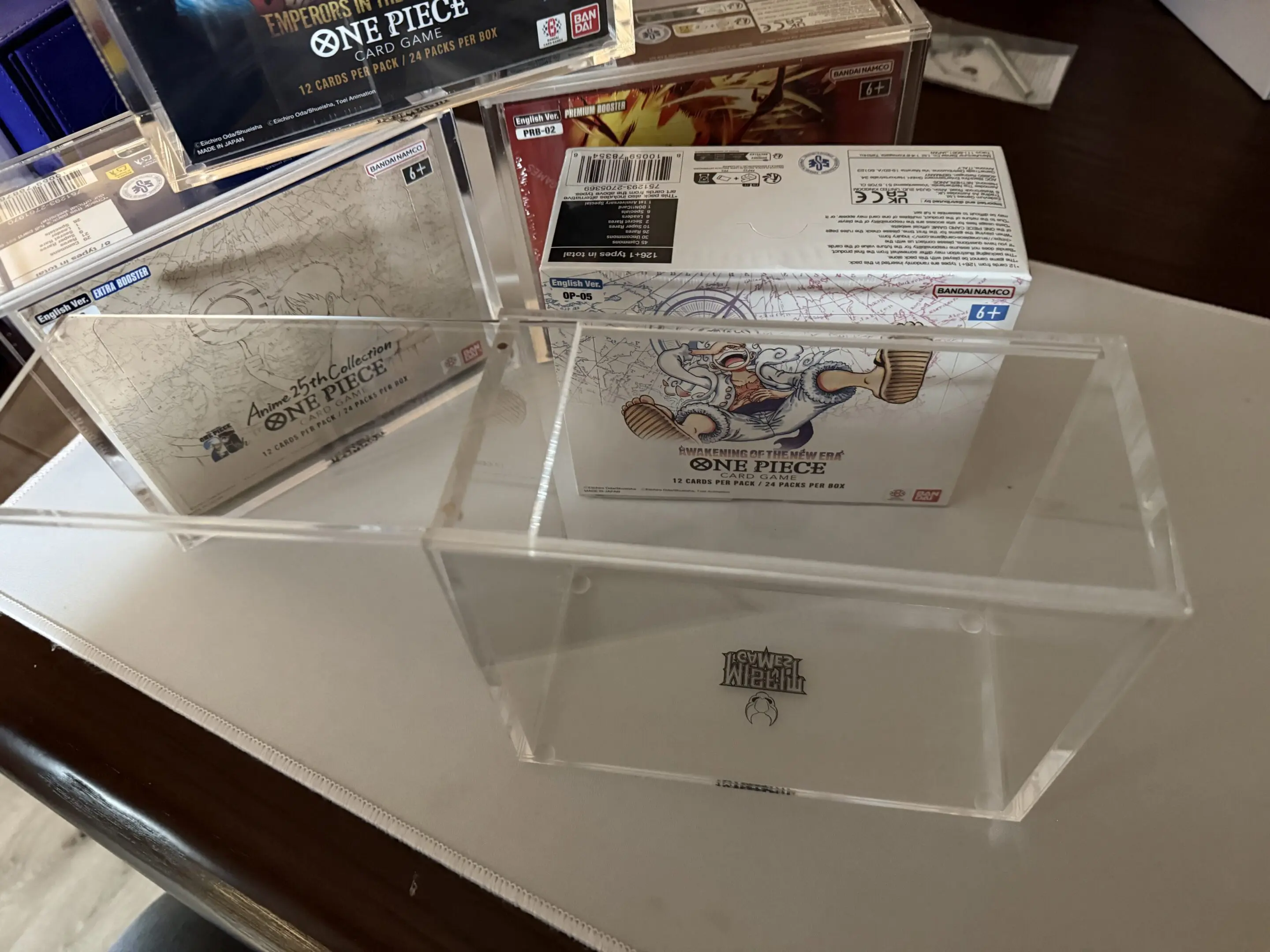 Limited edition collectible cards displayed in clear cases on a table.