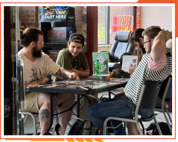 Group of young people hanging out at a café table, chatting and enjoying drinks.